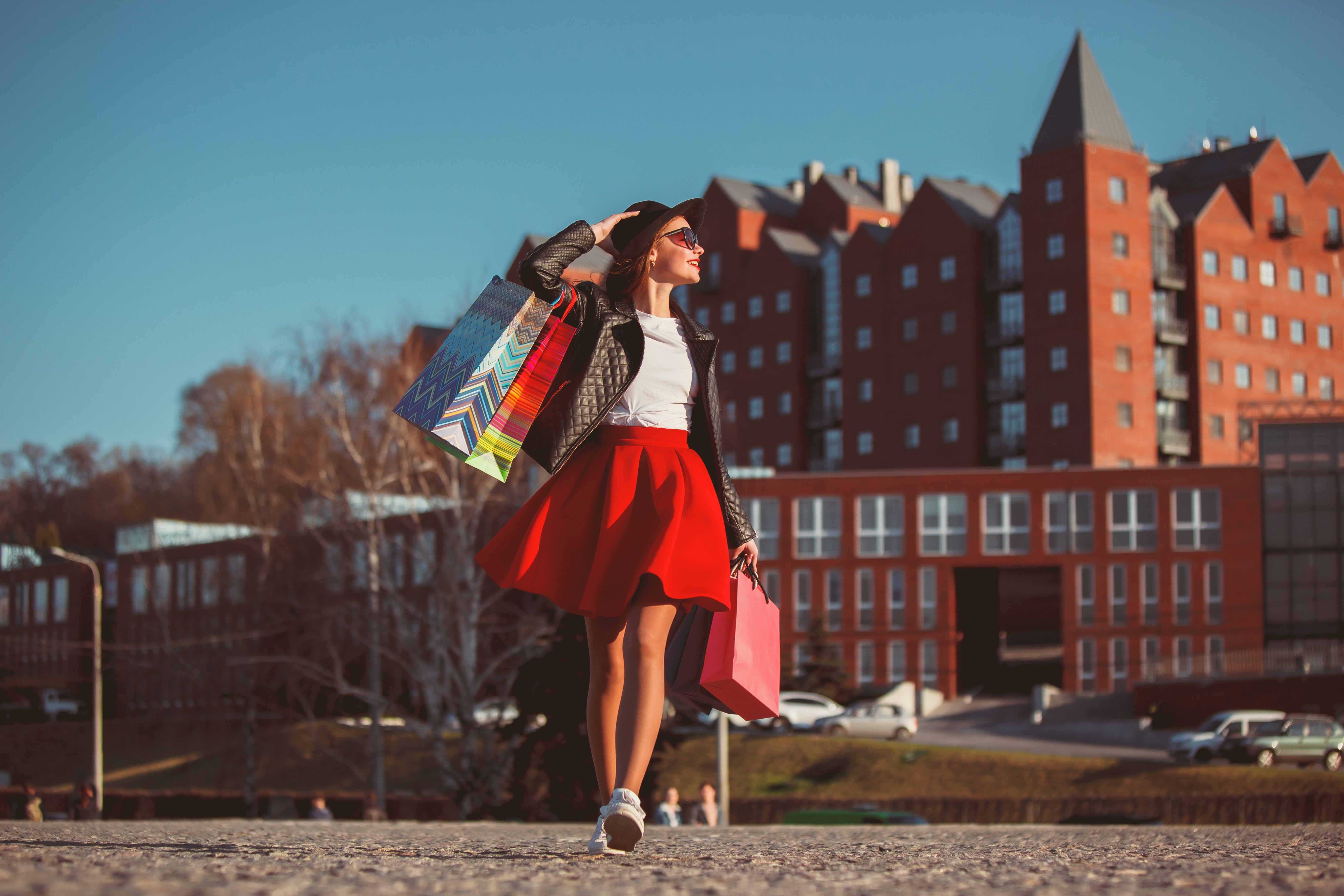girl-walking-with-shopping-bags-city-streets-sunny-day.jpg